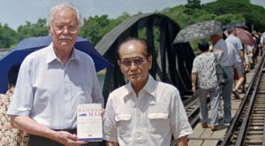 Eric Lomax and Nagase Takashi meet for the first time since the war on the Kwae River Bridge in Thailand. Lomax is holding a copy of his memoir The Railway Man (Photo: The Telegraph)